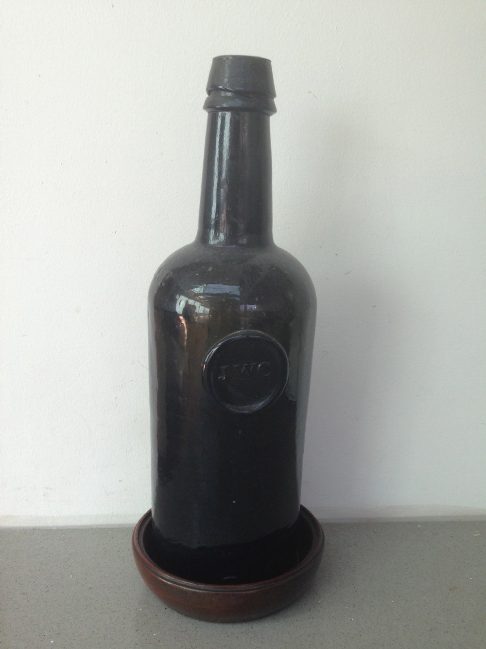 An antique mahogany wine coaster