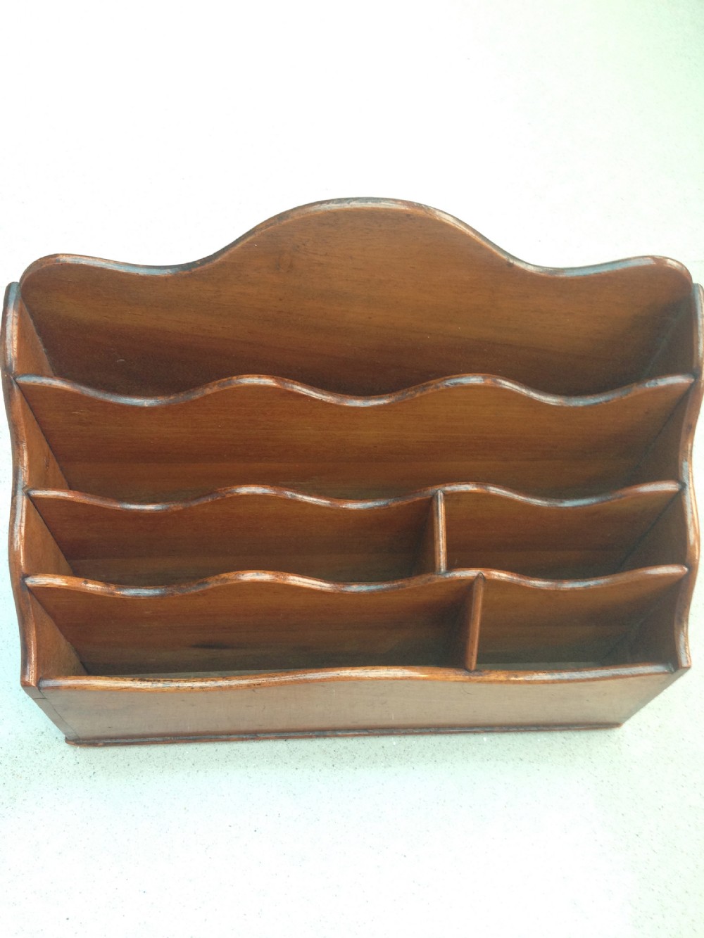 A mid 19th century mahogany stationery rack