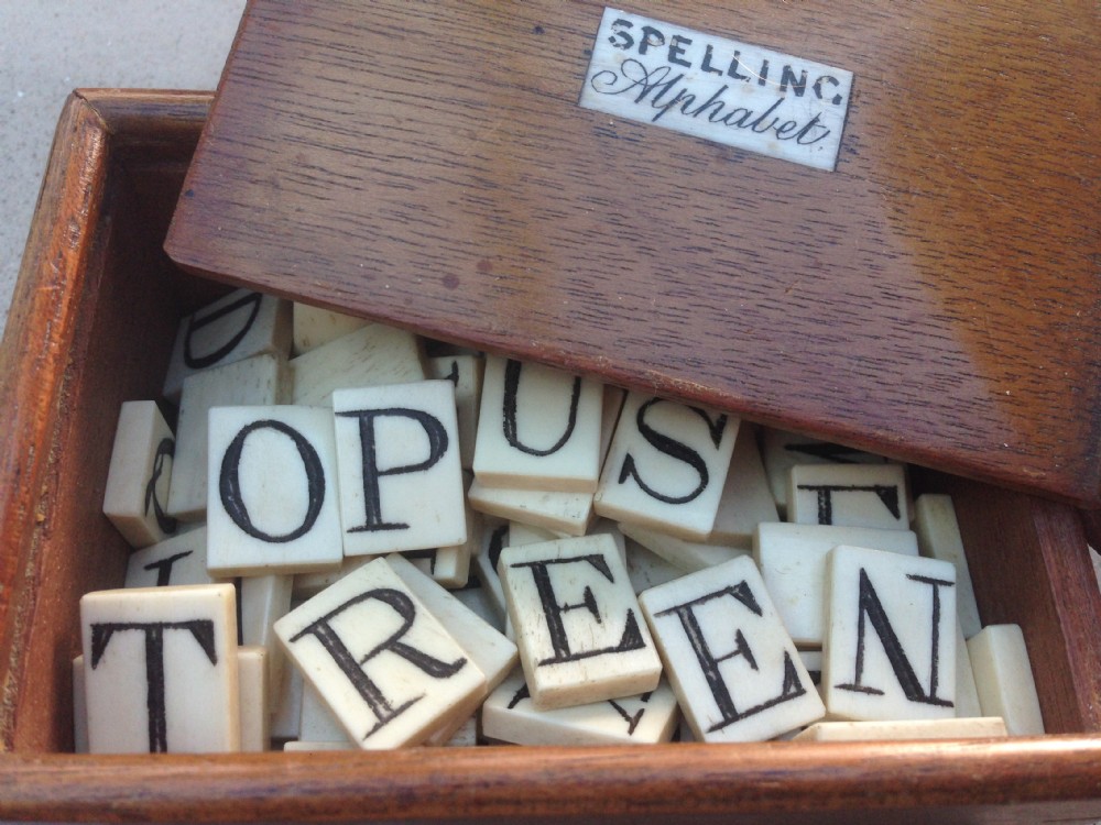 An unusual bone alphabet set in mahogany box