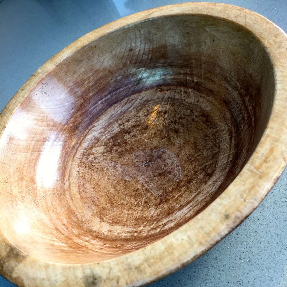 An antique fruit wood dairy bowl