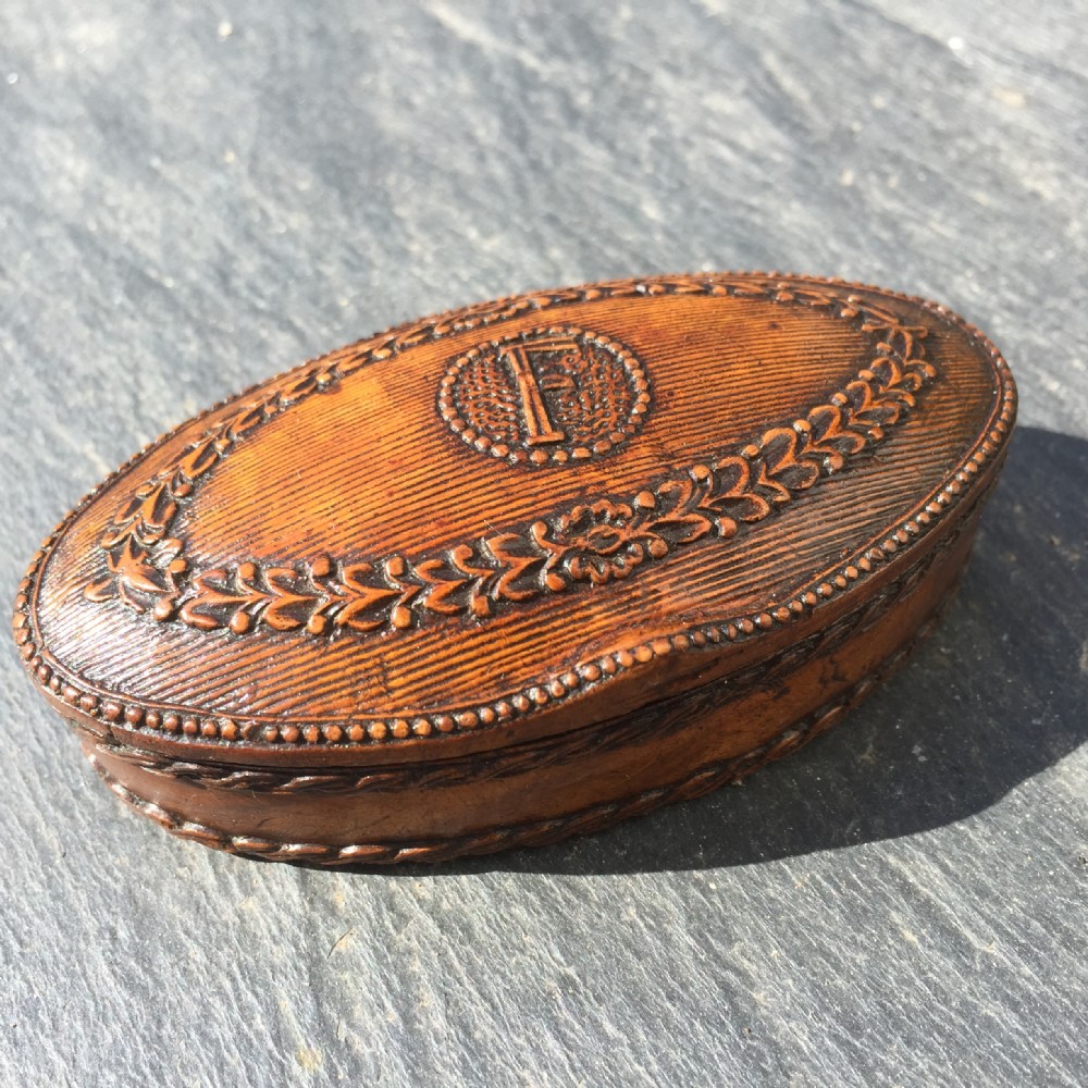 A well carved early 19th century snuff box
