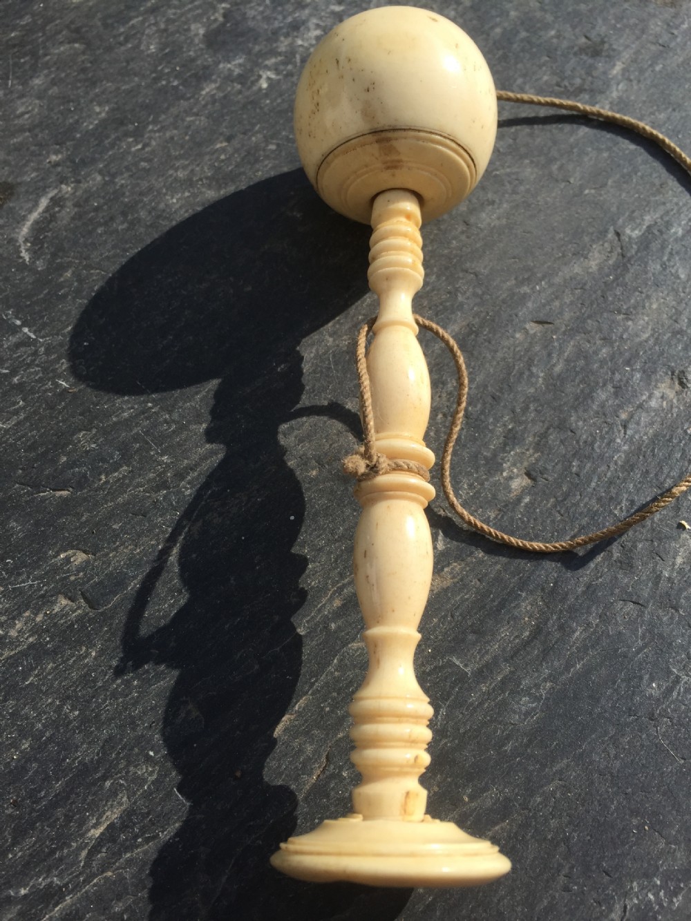 A 19th century bone bilboquet