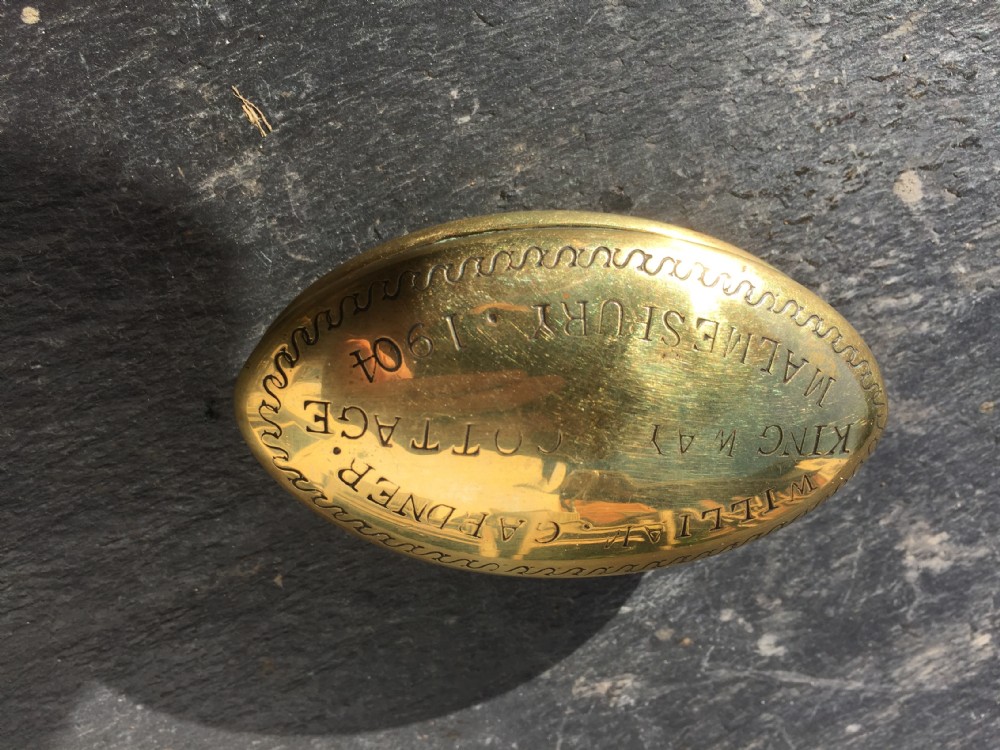 A brass miners snuff box dated 1904