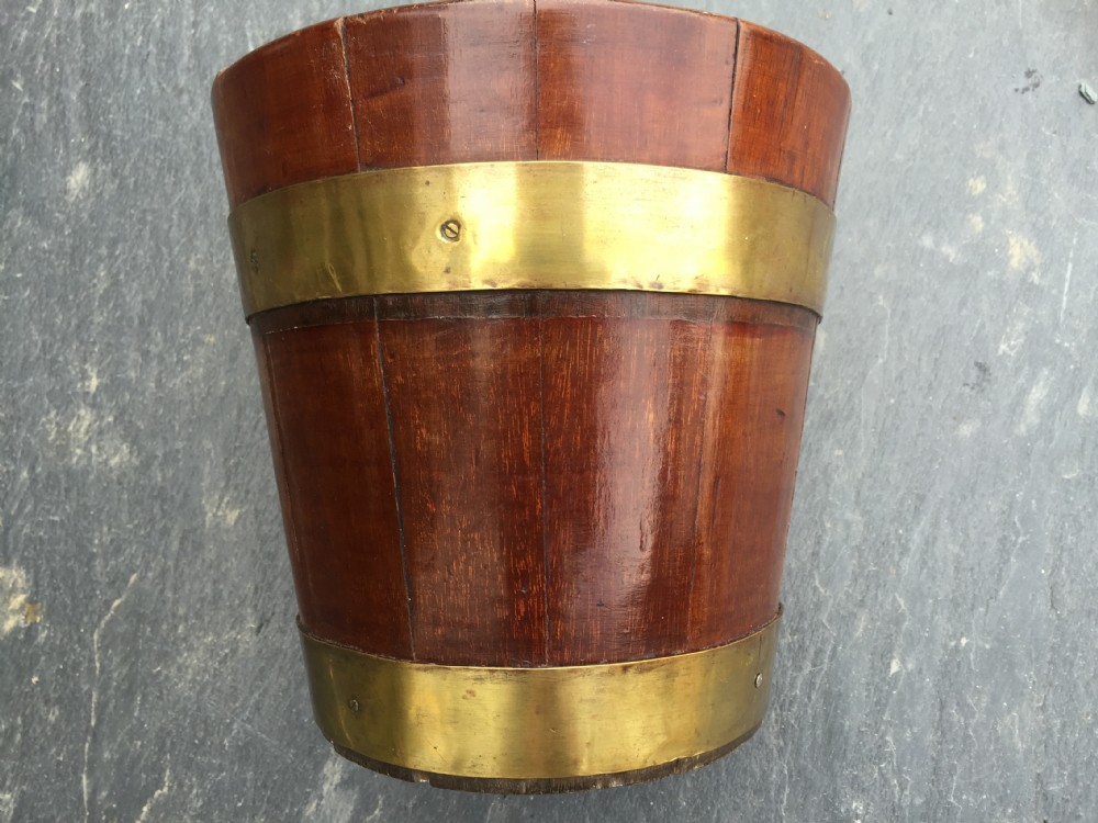 An antique mahogany brass bound bucket