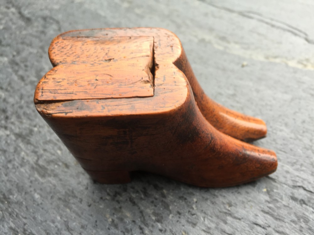 An antique snuff box in the form of two boots