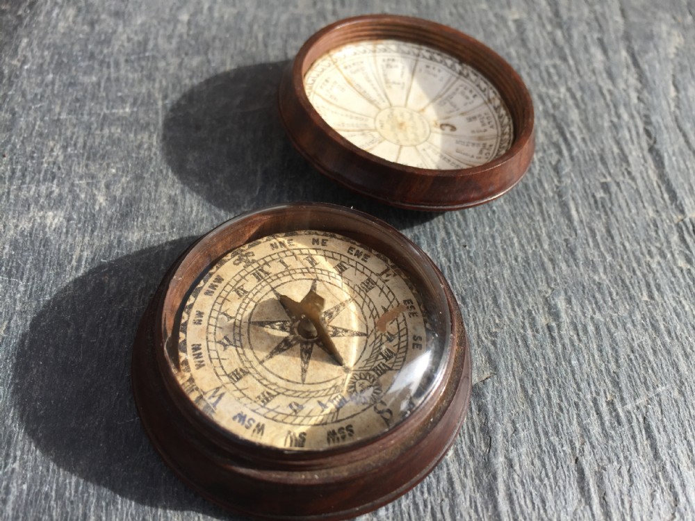 An early 19th century rosewood case with lid sundial and compass 