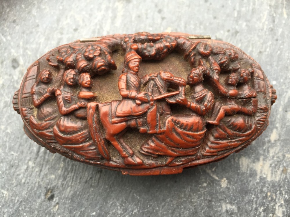 An early 19th century carved coquilla nut snuff box