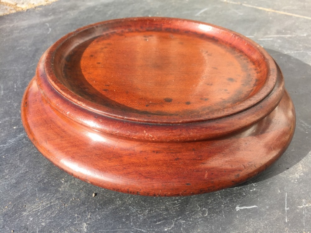 A large early 19th century mahogany wine coaster with brass casters