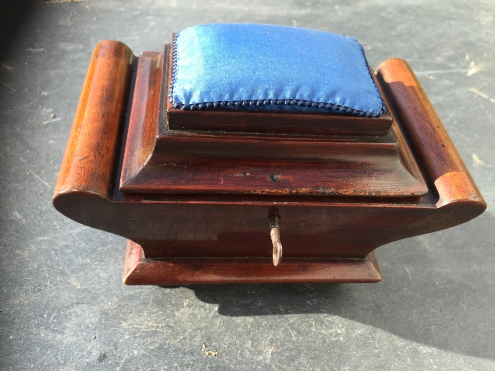 An early 19th century sarcophagus shaped mahogany sewing box - pin cushion box