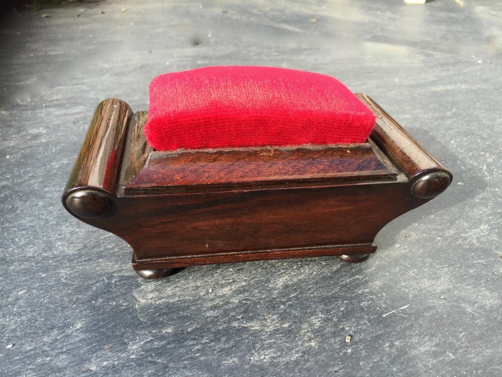 A Victorian rosewood pin cushion and sewing box