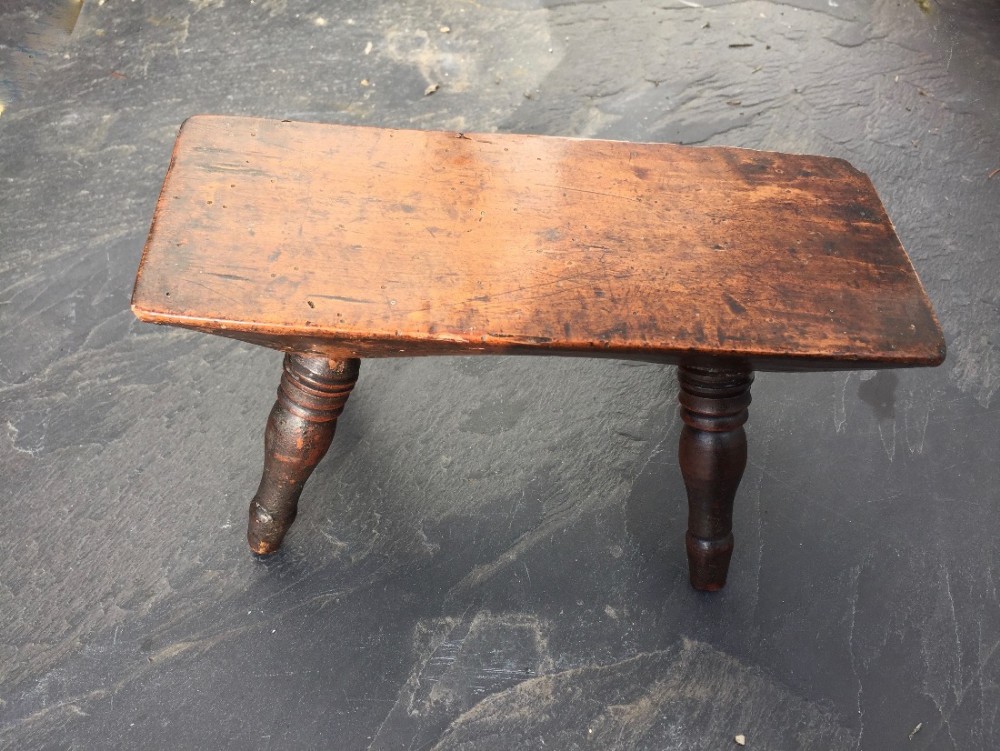 An unusually small fruit wood stool