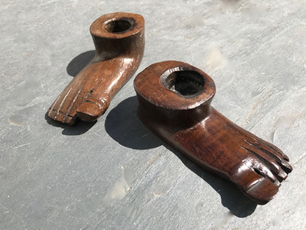 Two unusual 19th century oak candle sticks carved as feet