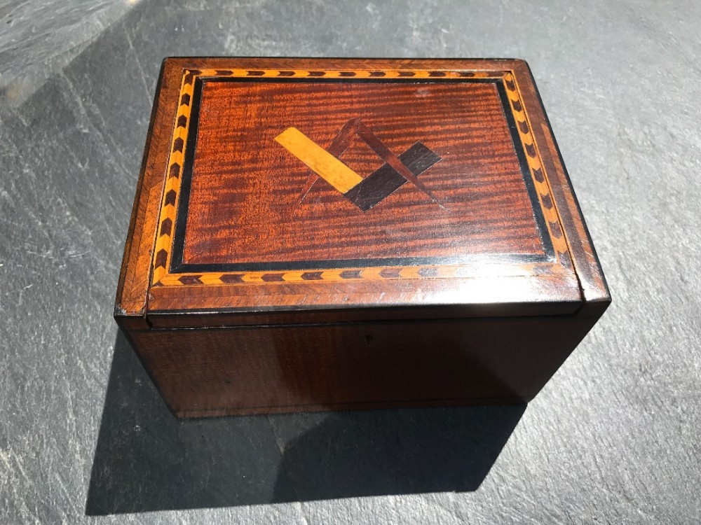 An early 19th century fiddle back mahogany box with masonic symbols