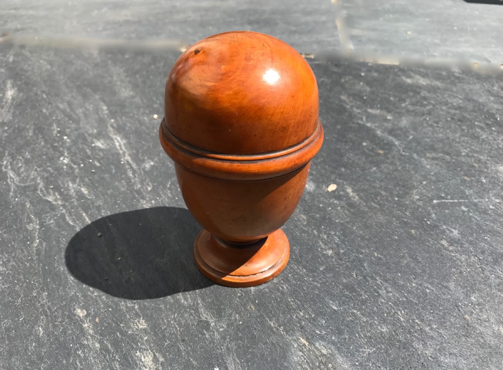 An unusual antique treen pill silverer and rounder