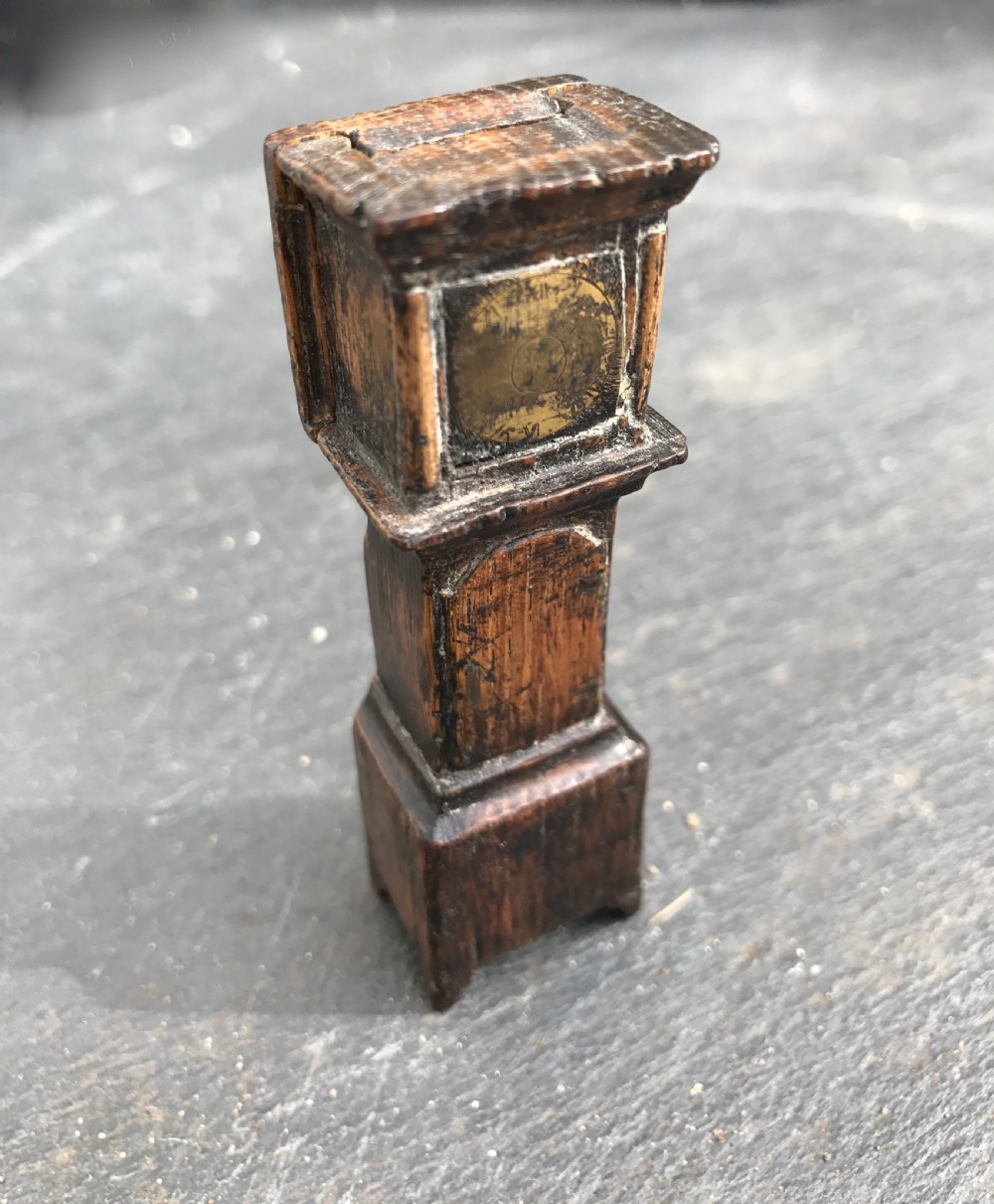 An antique snuff box in the form of a small grandfather 