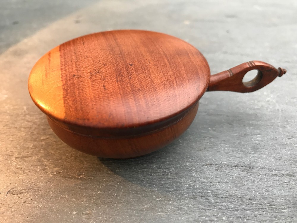 An unusual early 1800's cherry wood nutmeg grater in the shape of a saucepan View II