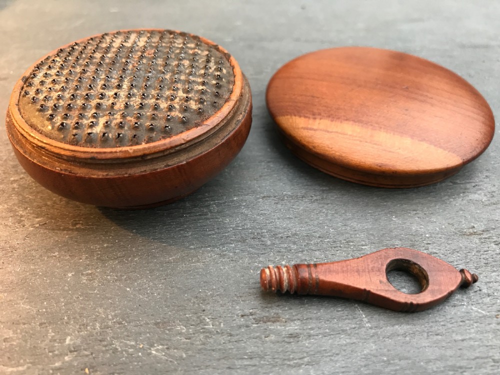 An unusual early 1800's cherry wood nutmeg grater in the shape of a saucepan View III