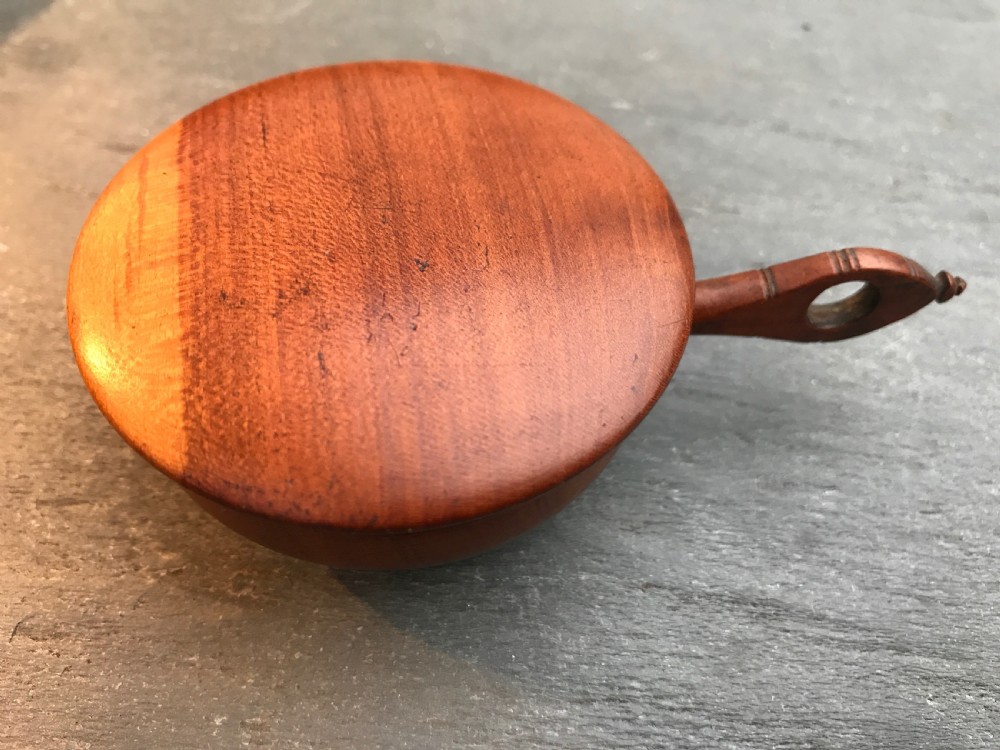 An unusual early 1800's cherry wood nutmeg grater in the shape of a saucepan View IV