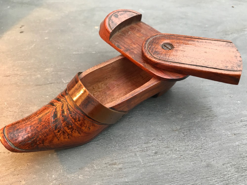 A lovely fruitwood antique treen puzzle snuff shoe with a lovely copper strap to the front View II