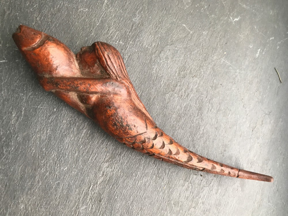 A rare shaped treen knitting sheath in the shape of a mermaid 