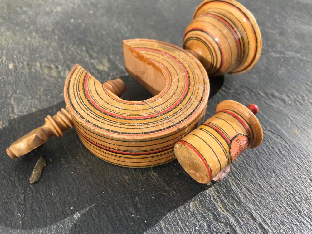 An early 19th century painted Tunbridge Ware sewing clamp, pin cushion and tape measure View II