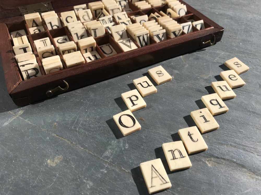 A 19th century mahogany boxed set of bone alphabet tiles View II