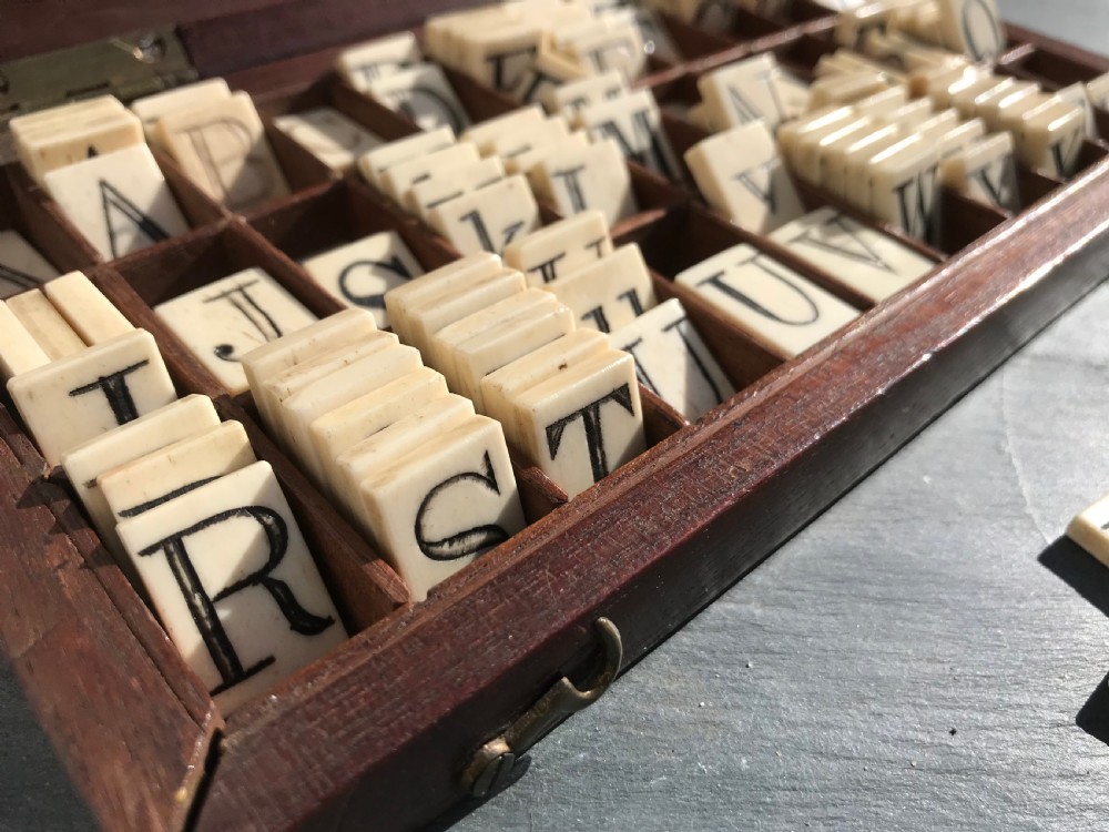 A 19th century mahogany boxed set of bone alphabet tiles View III