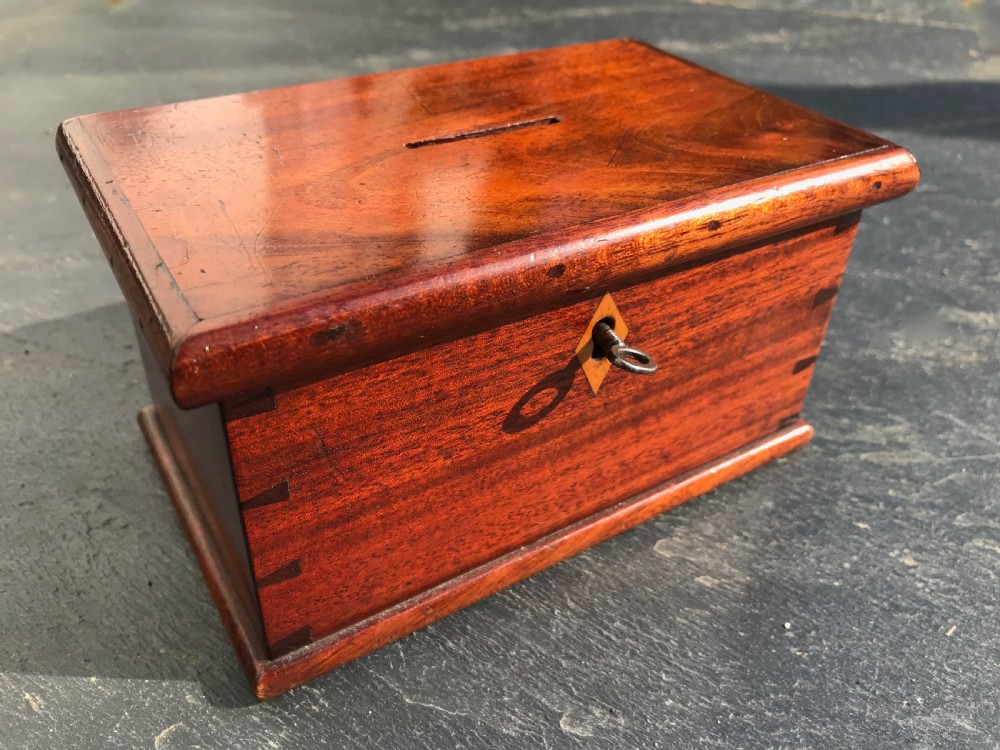An antique money box in the form of a chest