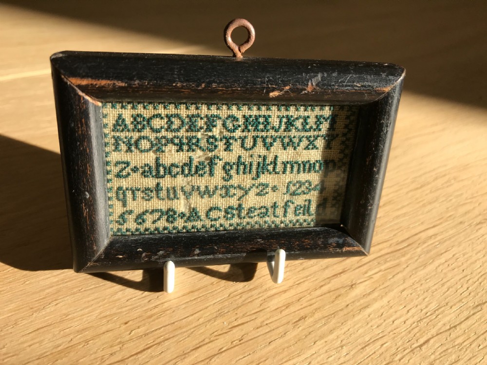An unusually small 19th century sampler