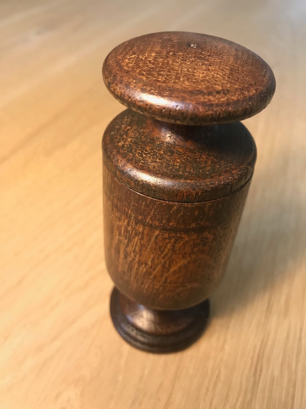 An antique treen spice or apothecary grinder