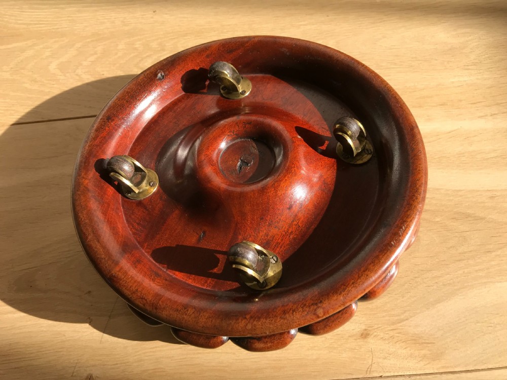 A superbly carved 19th century mahogany wine coaster - on four castors View II