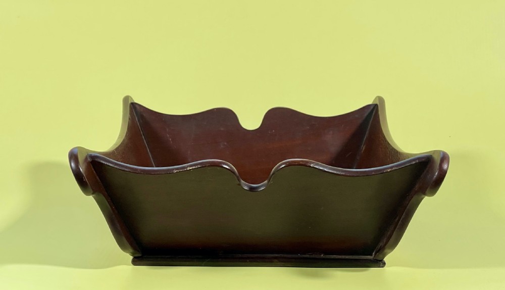 A Georgian mahogany deep wooden container featuring flared scalloped side rims and a rectangular base. View III