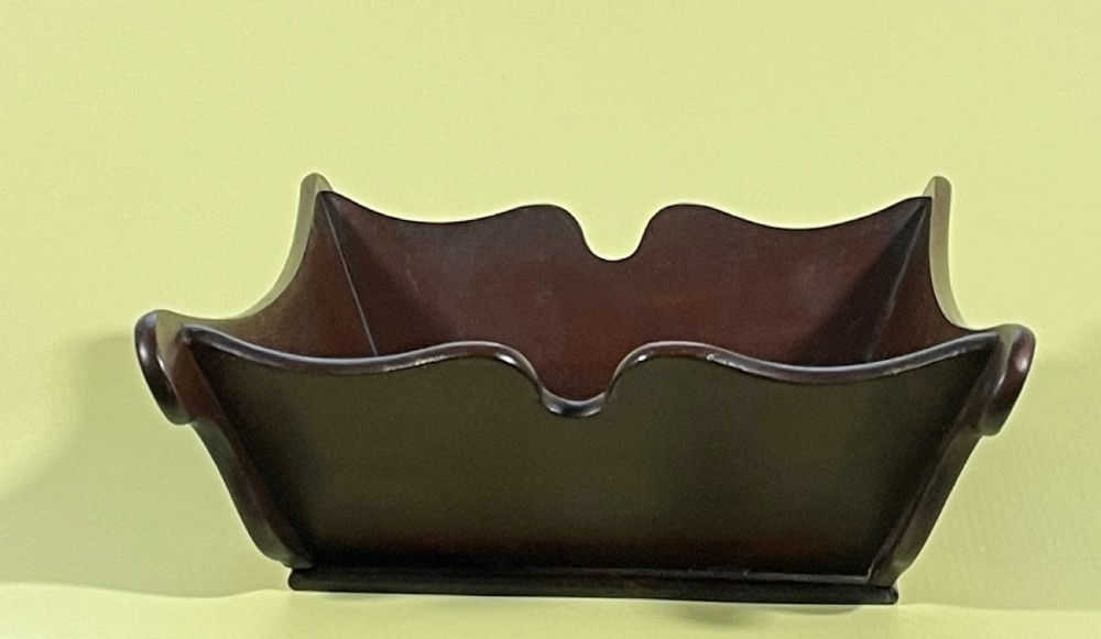 A Georgian mahogany deep wooden container featuring flared scalloped side rims and a rectangular base. View IV