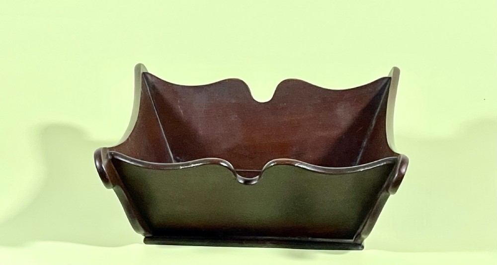 A Georgian mahogany deep wooden container featuring flared scalloped side rims and a rectangular base. View VI