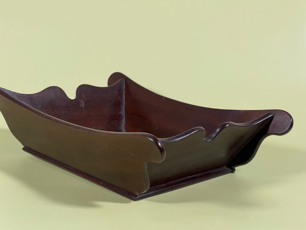A Georgian mahogany deep wooden container featuring flared scalloped side rims and a rectangular base. View XII