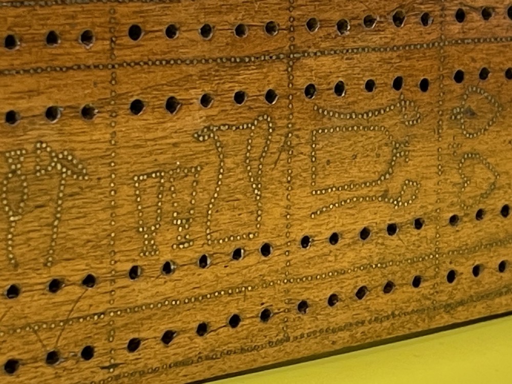 An Unusual Cribbage Board - with hearts, clubs, diamonds, spades  goblets, jugs and dated View IV