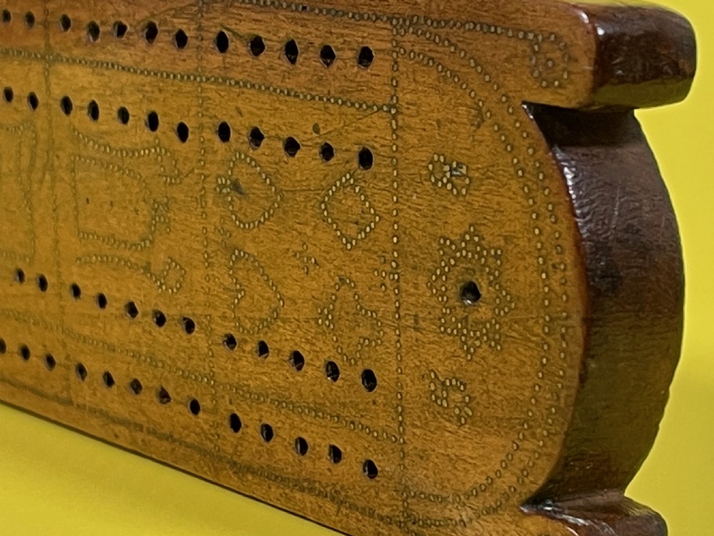 An Unusual Cribbage Board - with hearts, clubs, diamonds, spades  goblets, jugs and dated View VI