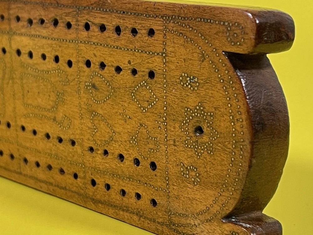 An Unusual Cribbage Board - with hearts, clubs, diamonds, spades  goblets, jugs and dated View VII