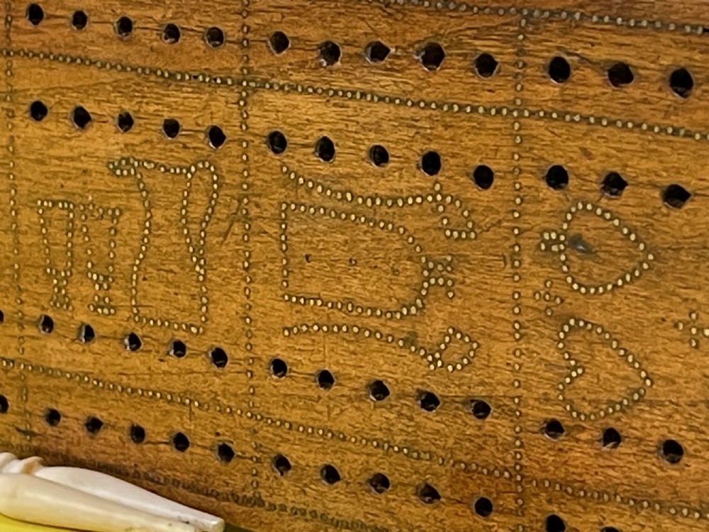 An Unusual Cribbage Board - with hearts, clubs, diamonds, spades  goblets, jugs and dated View VIII