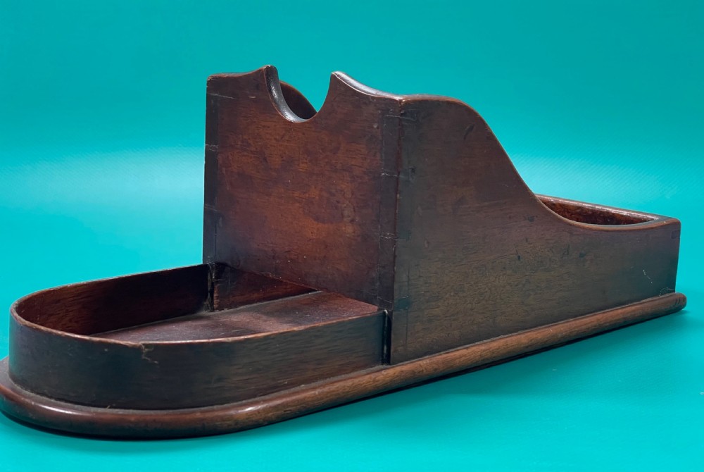 A Georgian mahogany wine bottle slope or cradle
