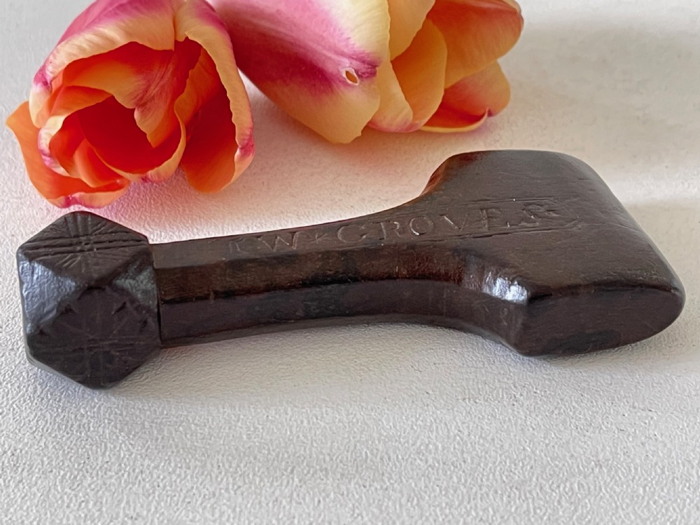 A very good antique treen sailor's rubber - faceted handle