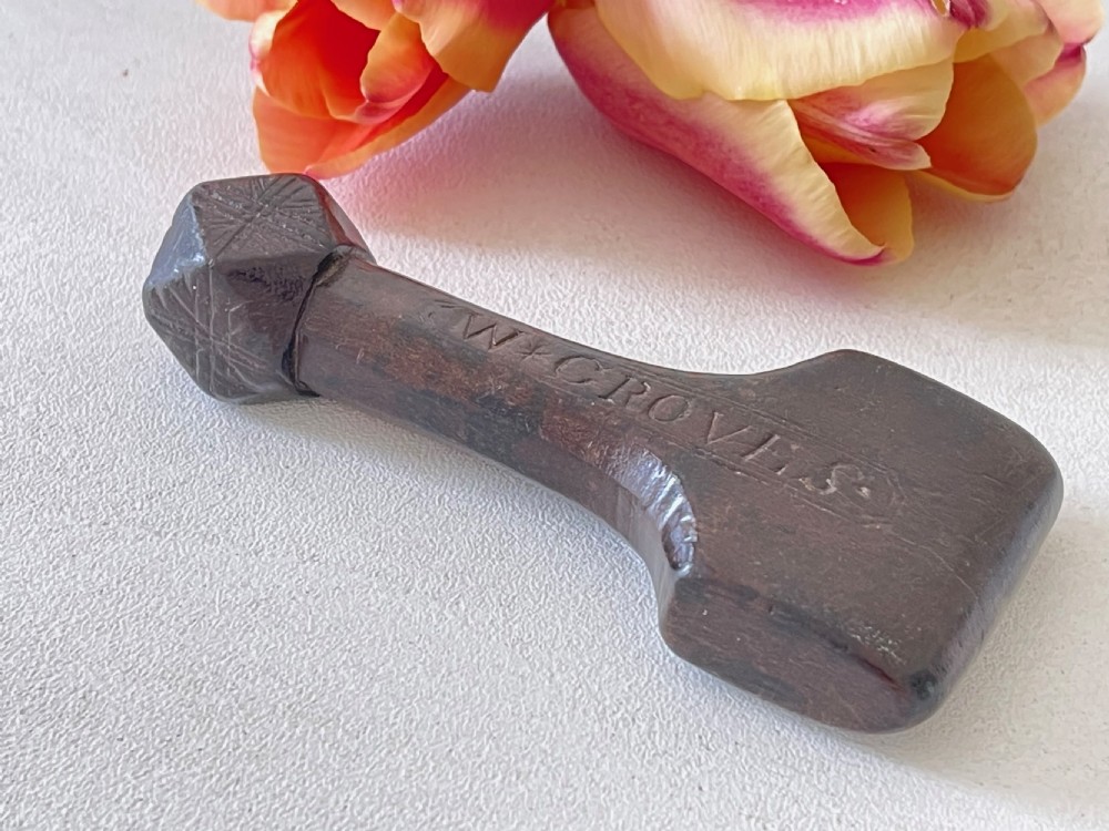 A very good antique treen sailor's rubber - faceted handle View V