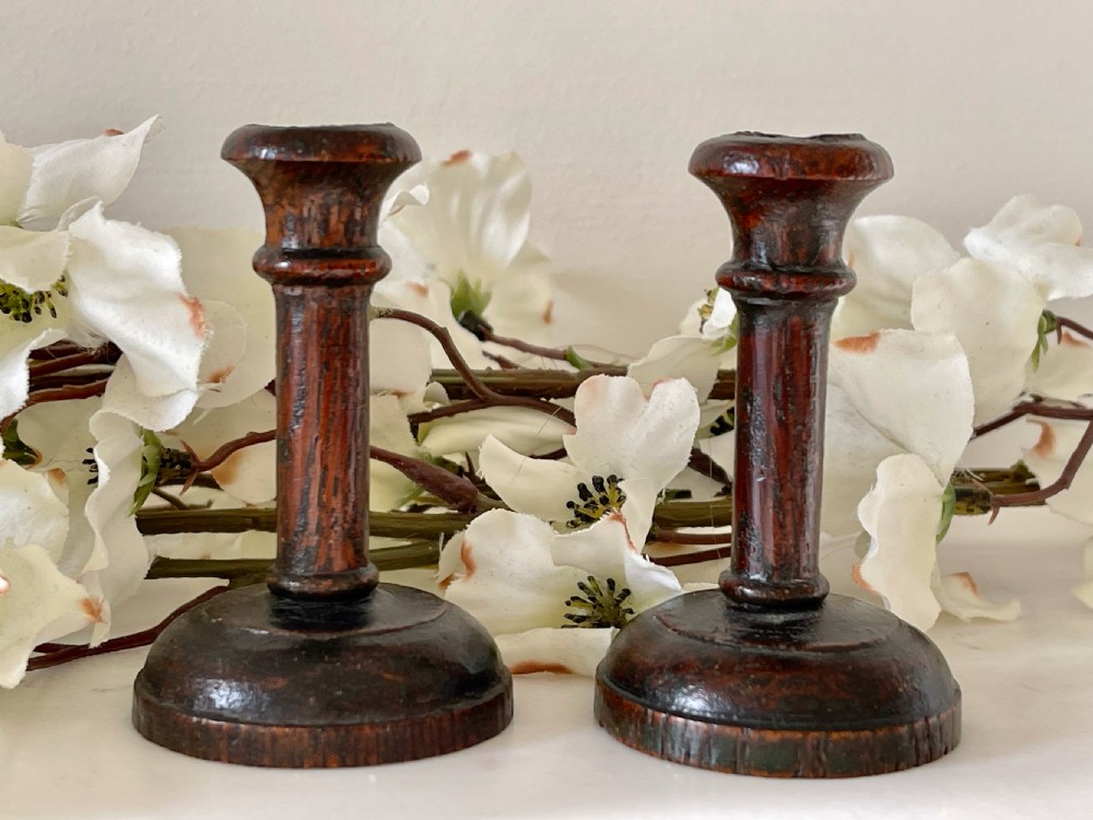 A Pair Of Antique Treen Taper Candlesticks