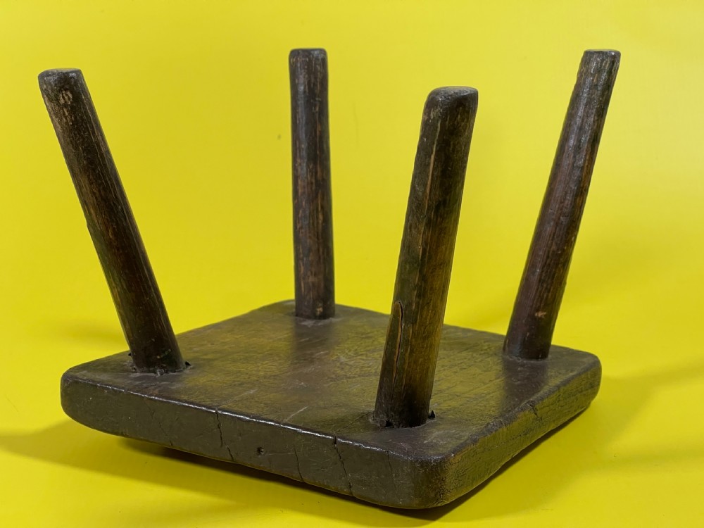 An Antique Stool with remnants of the old green paint View III