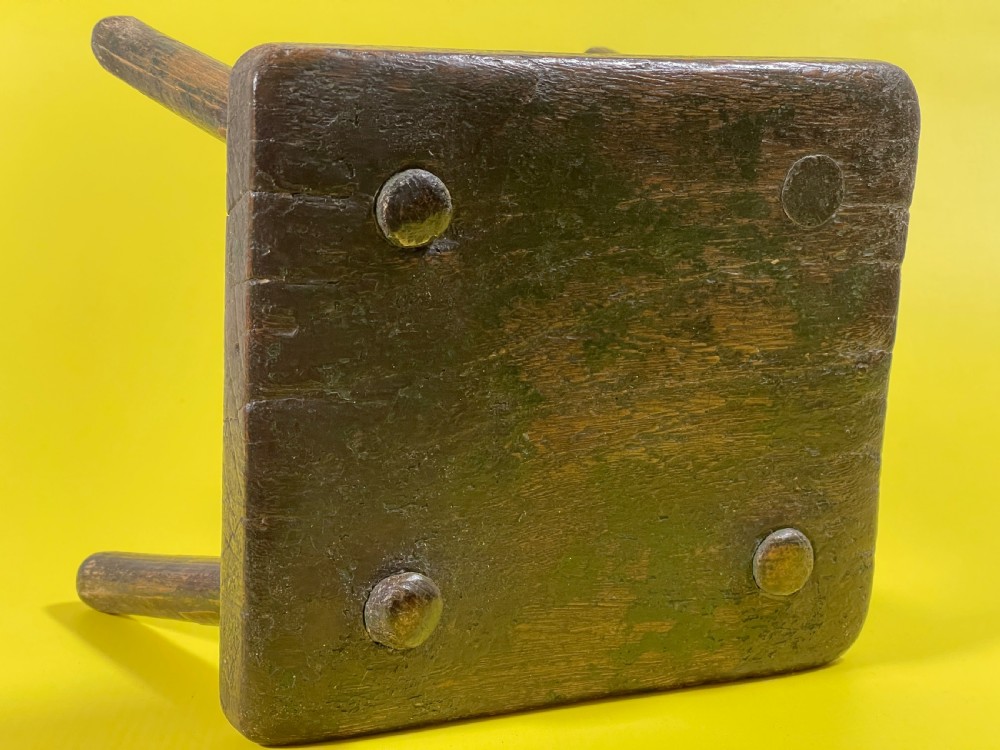 An Antique Stool with remnants of the old green paint View V