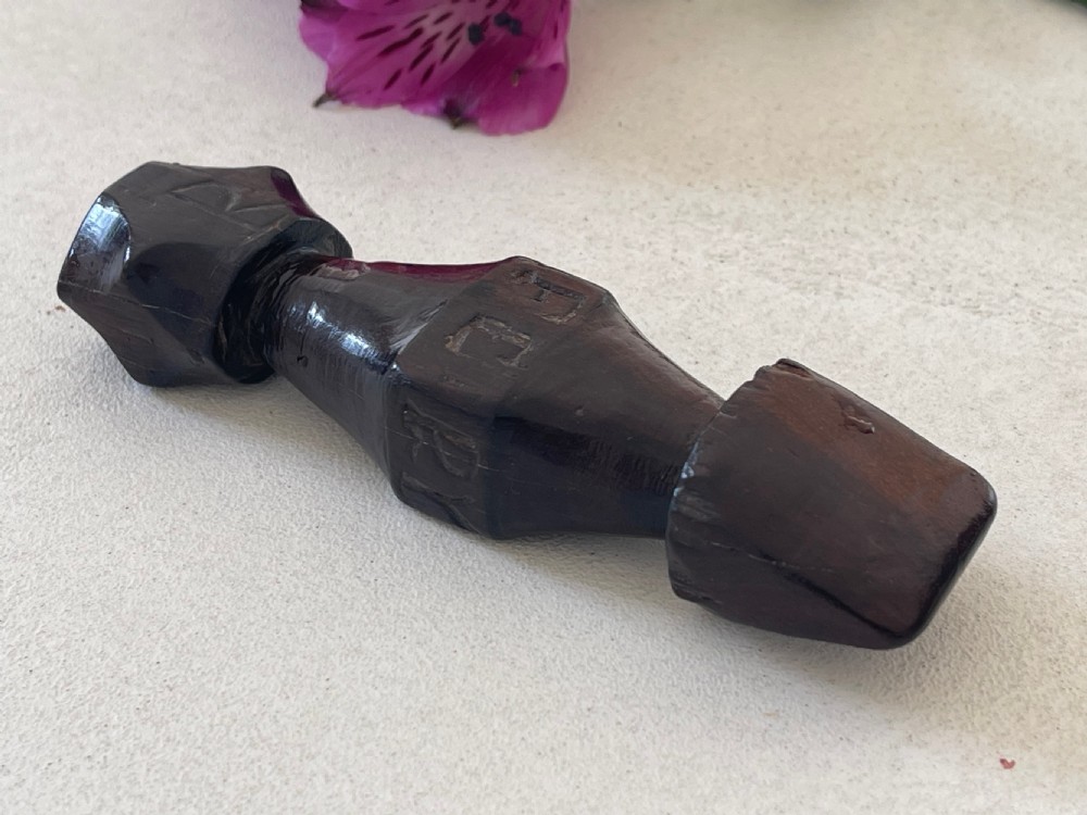 An antique treen sailors rubber 