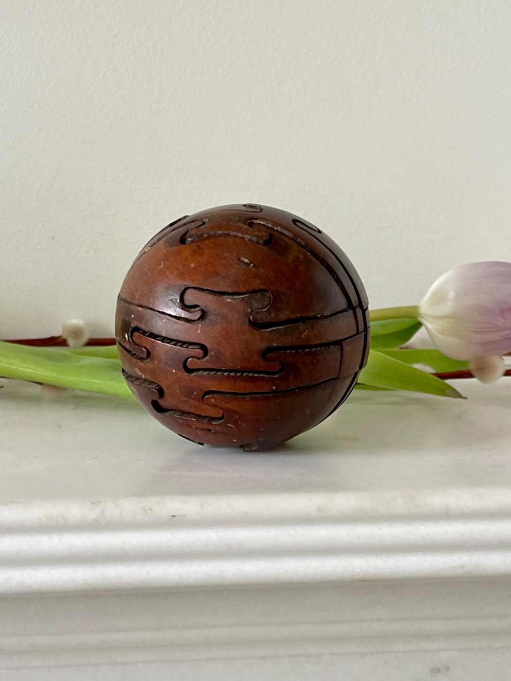 An early 1900's antique treen jigsaw in the shape of a wooden ball View IV