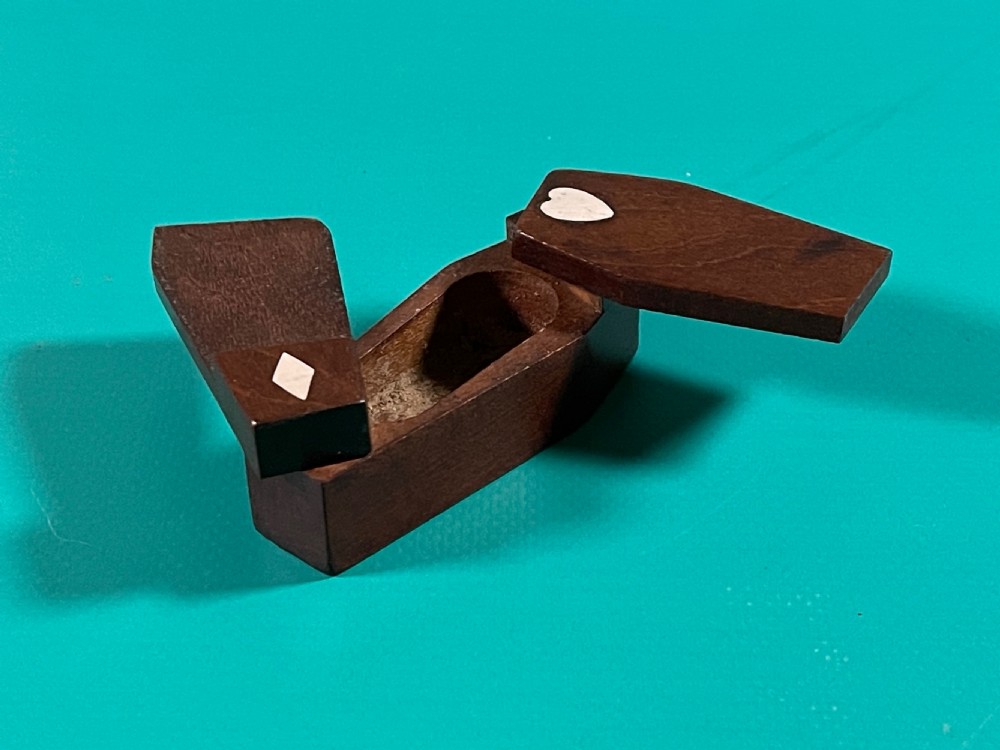 A small dark wood coffin-shaped antique snuff box featuring a swivelling lid with inlaid heart and diamond shapes. View II