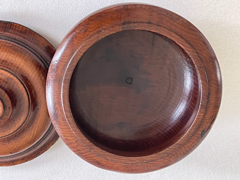 A turned yew wood spice pot featuring a stepped lidded top and a circular pedestal base. View II