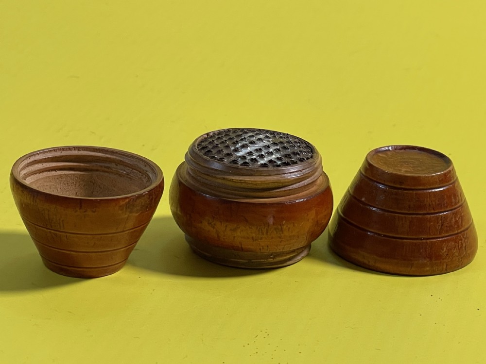 A small turned wooden barrel-shaped antique nutmeg grater with incised line detailing. View II